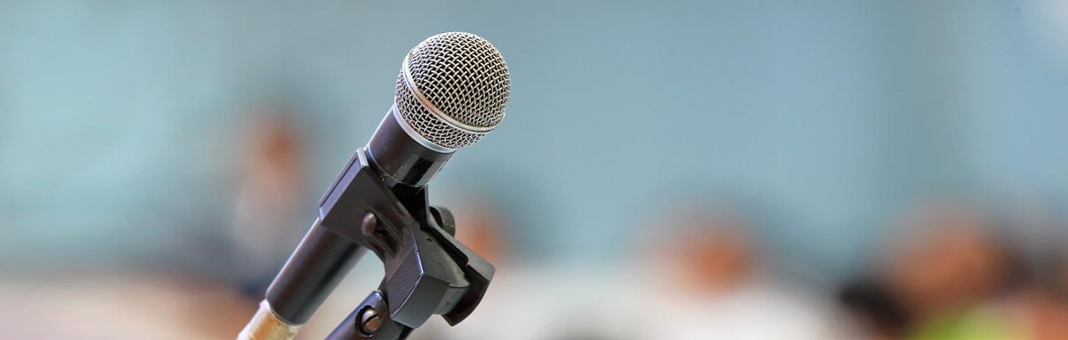 An image of a microphone set up for a speaker in a lecture room