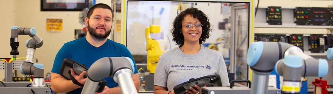 A male and female student working in PCC's Automated Industrial Technology lab. 